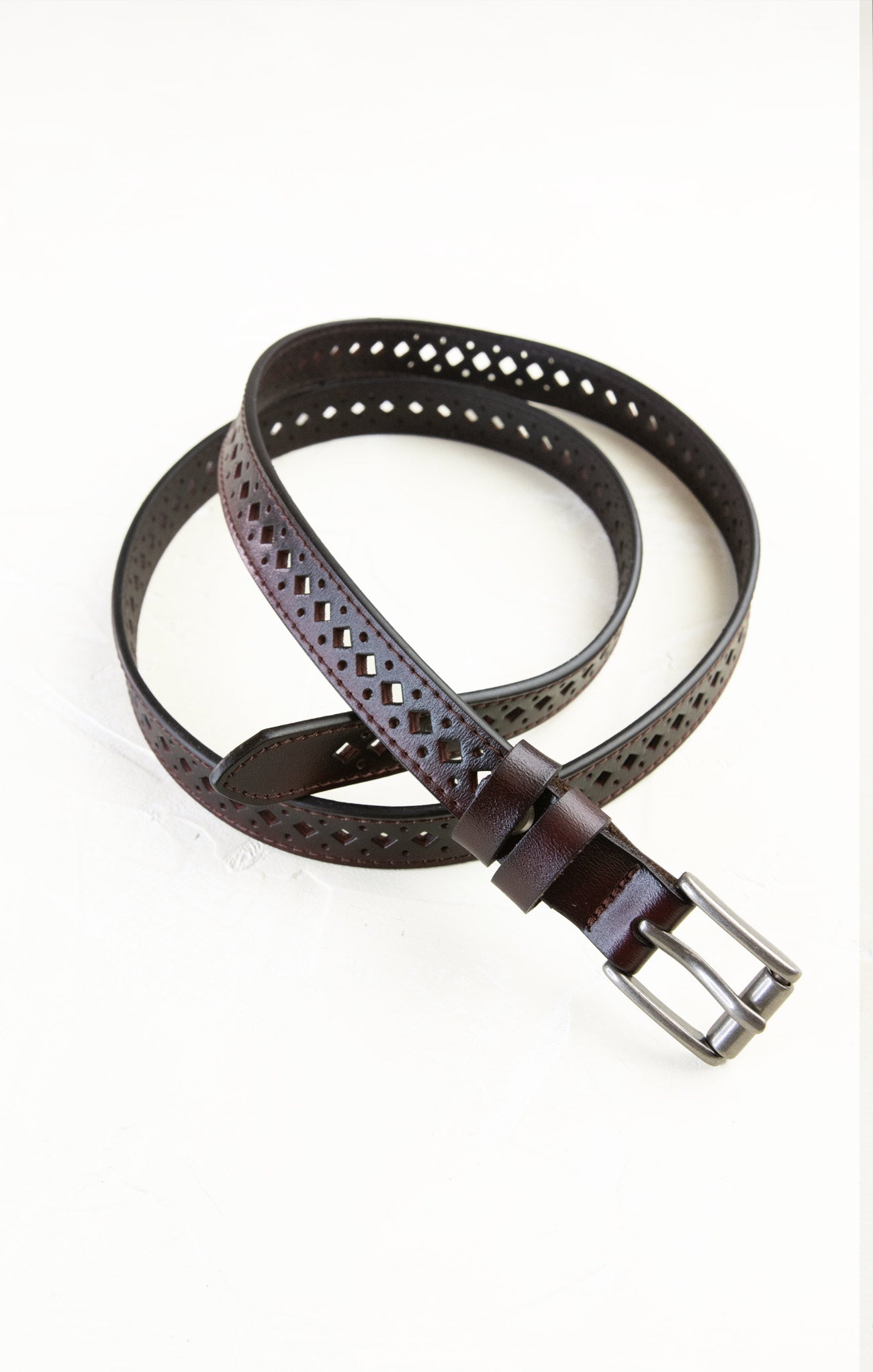 Brown leather belt with perforated design on a white background