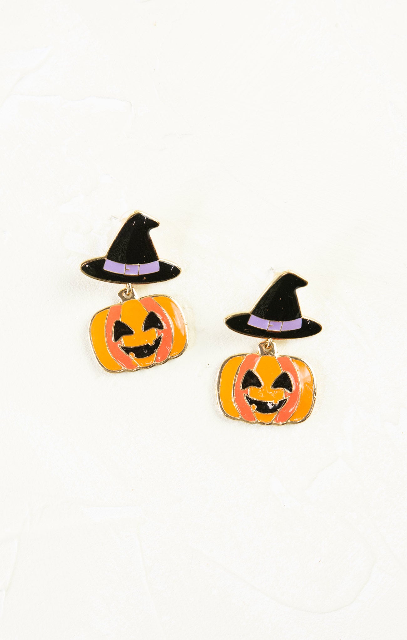 Halloween-themed earrings with jack-o'-lanterns and witch hats on a white background