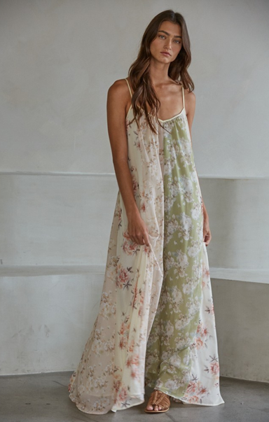 Woman wearing a floral dress against a plain background