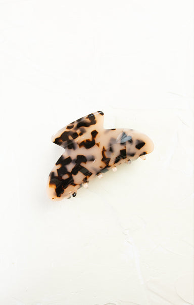 Leopard print hair clip on a white background