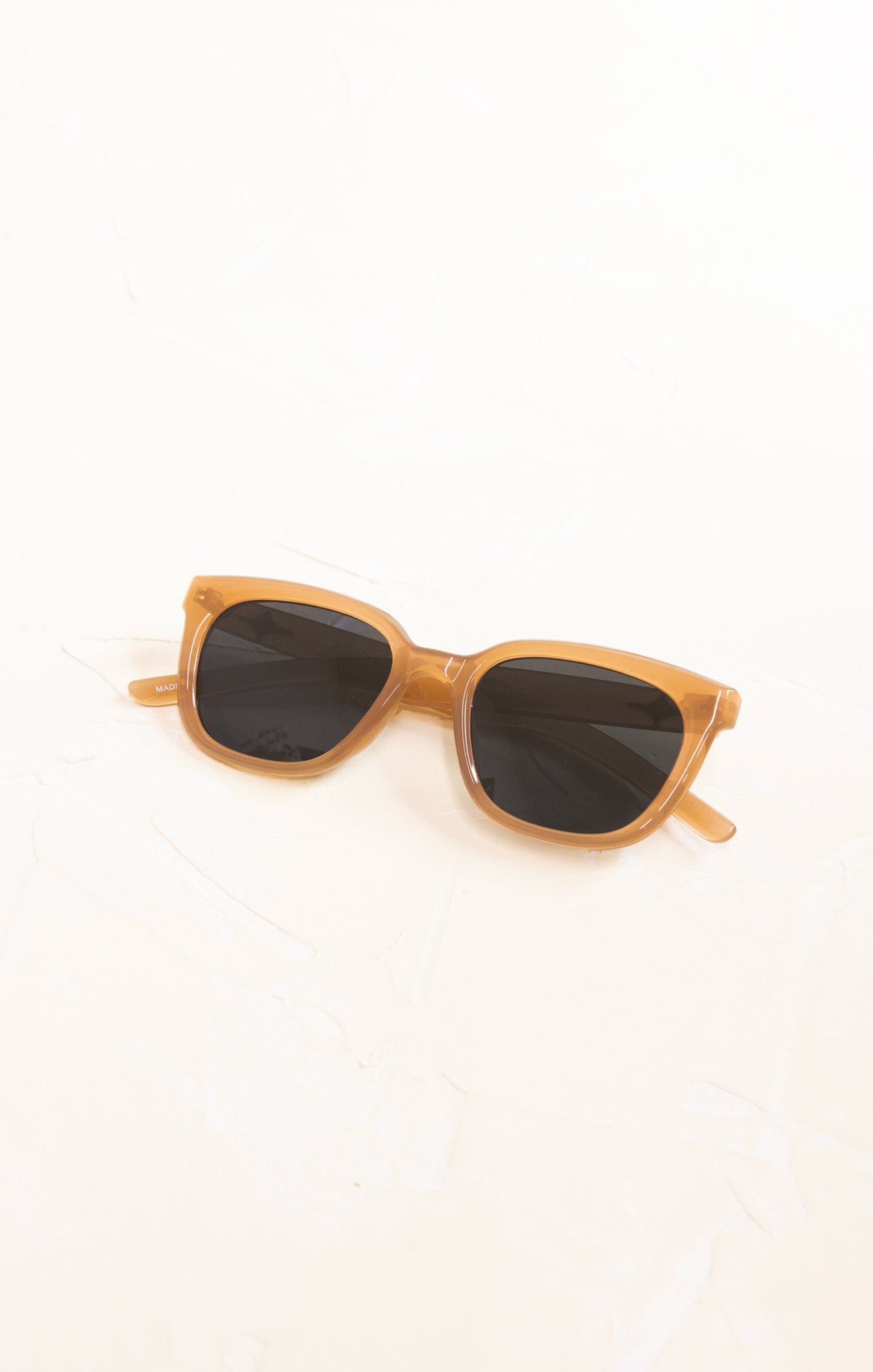 Sunglasses with wooden frame and dark lenses on a white background