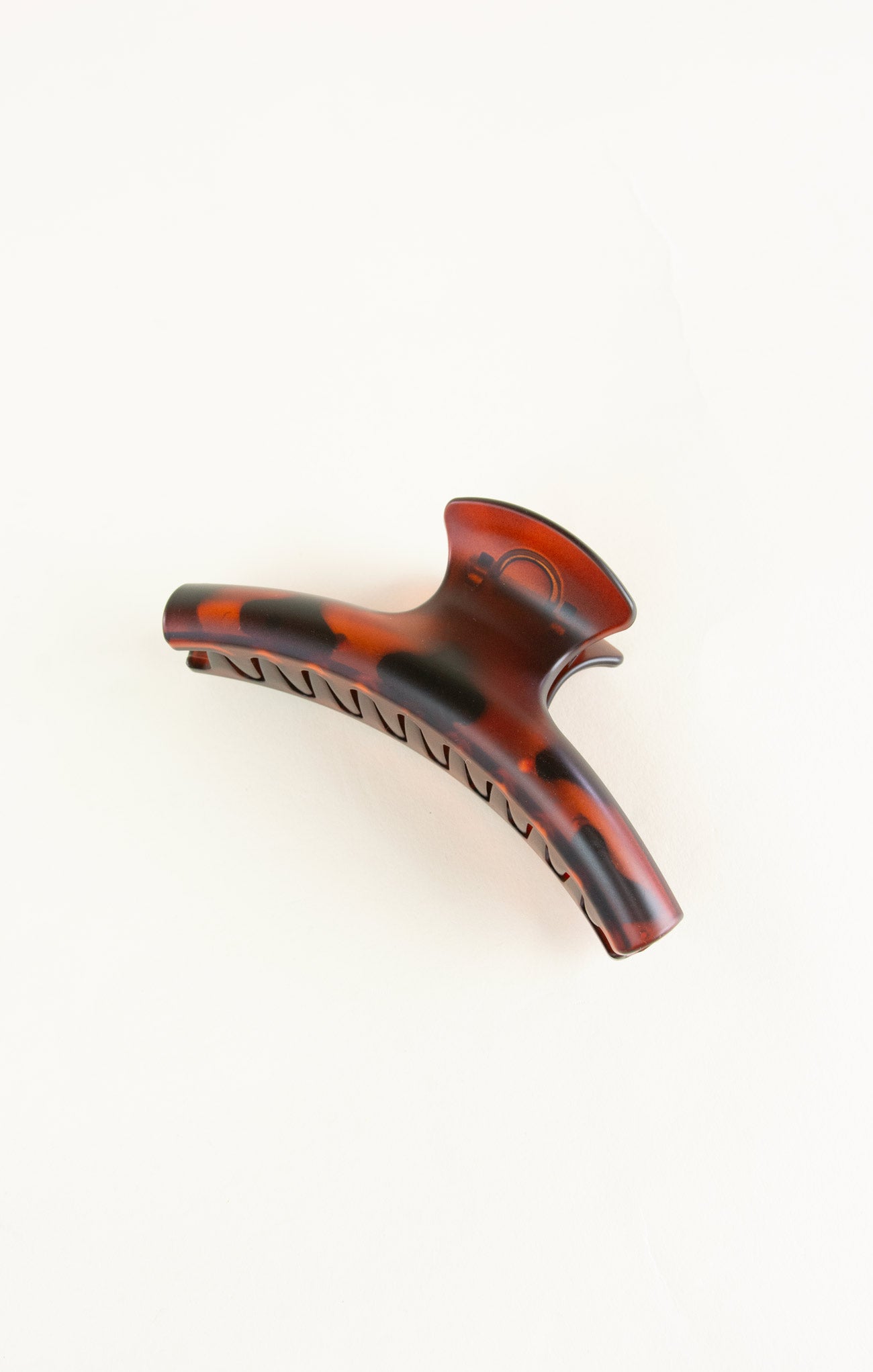 Tortoiseshell patterned hair clip on a white background
