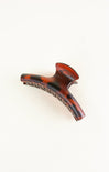 Tortoiseshell patterned hair clip on a white background