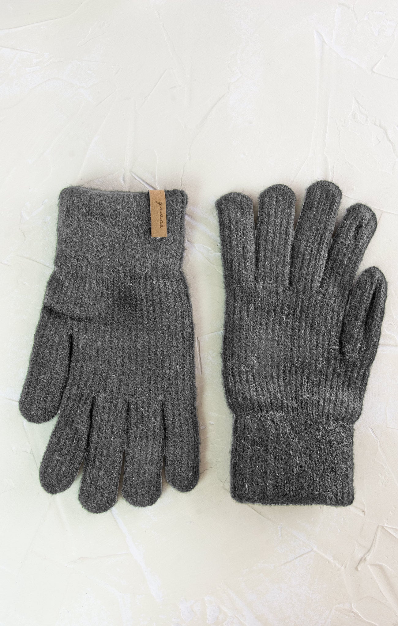 Pair of gray gloves on a light background