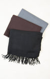 Three scarves in black, brown, and gray on a white background