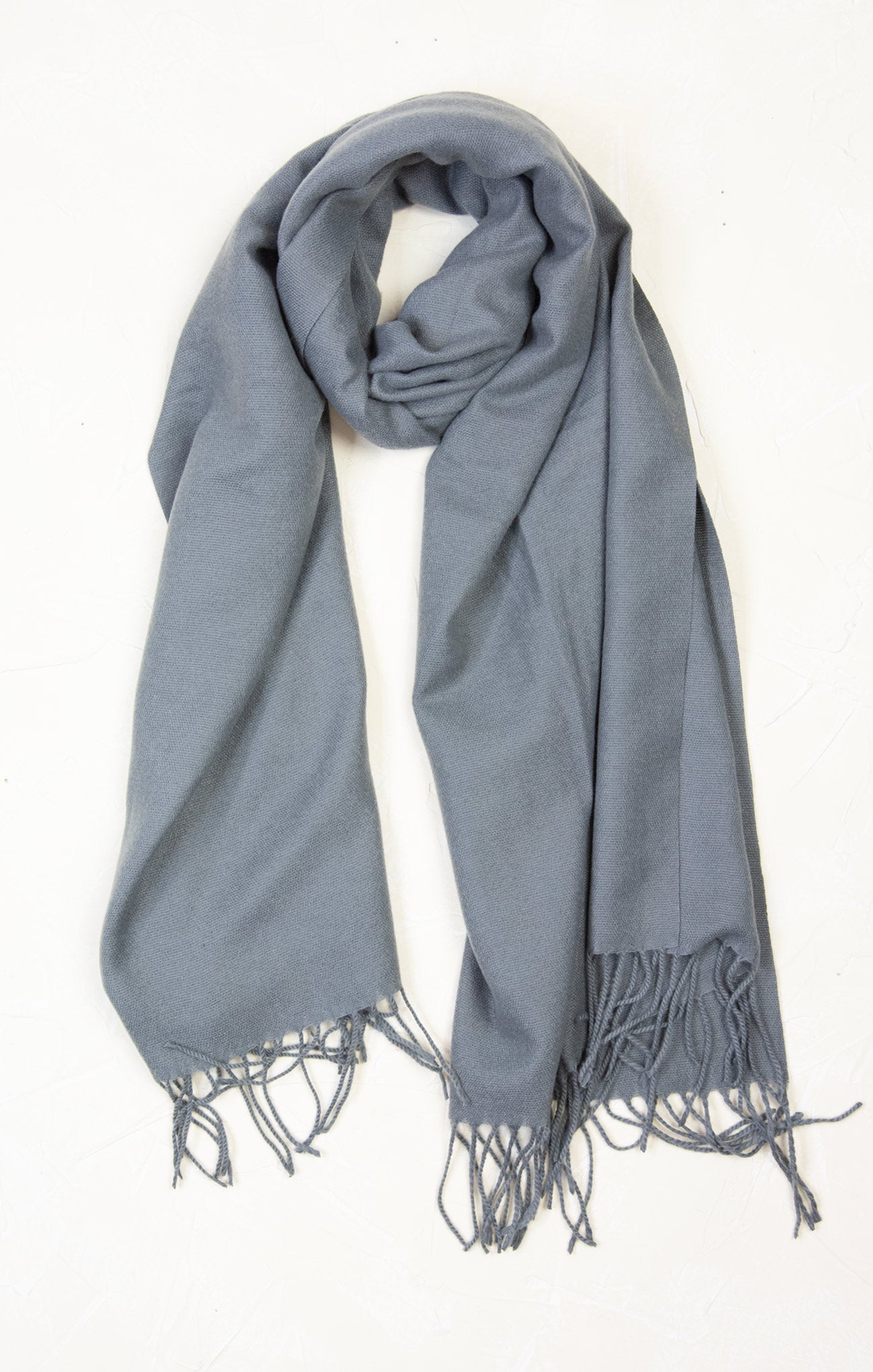 Gray scarf with tassels on a white background