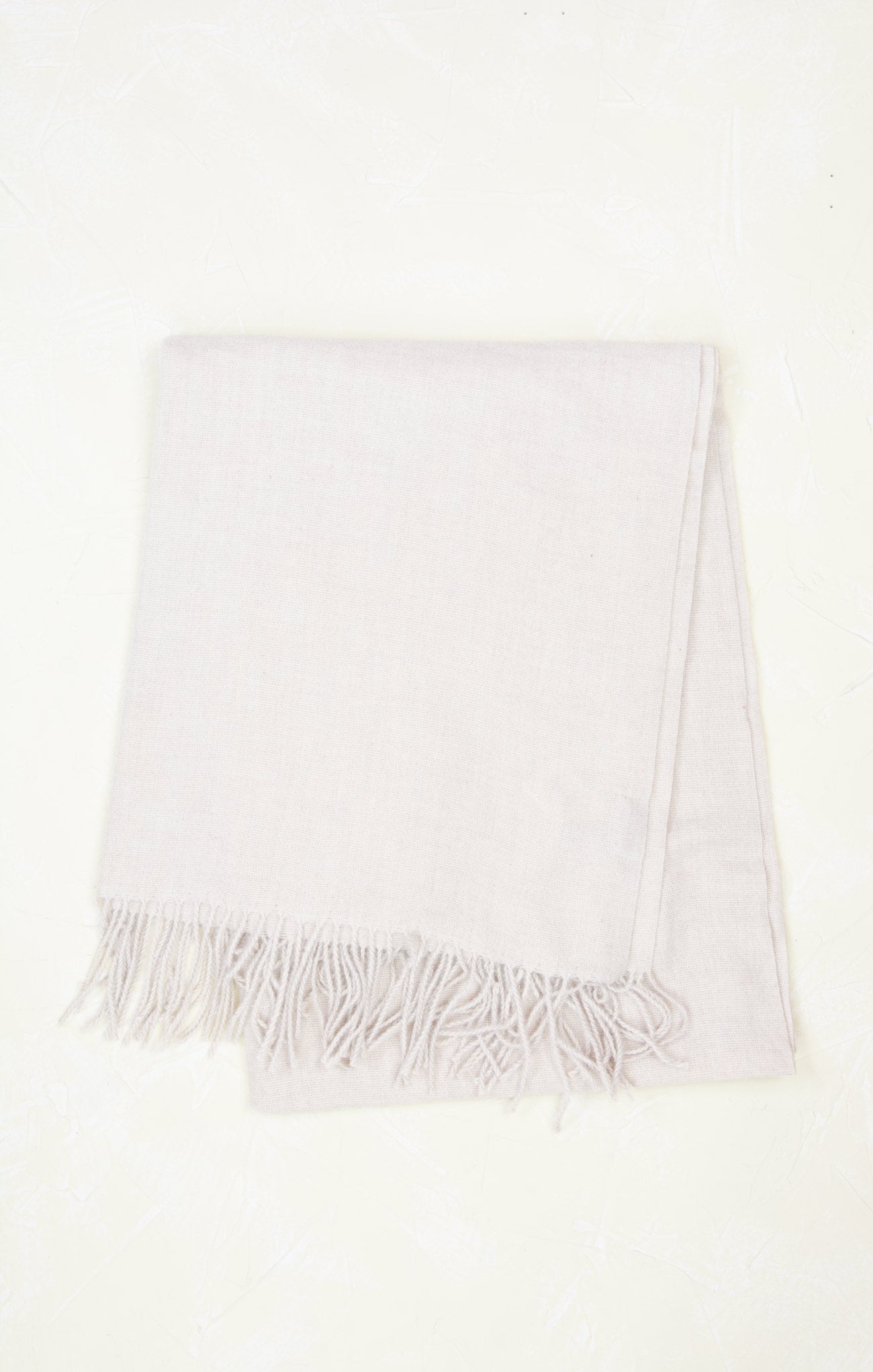 White scarf with fringe on a white background