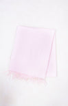 Light pink scarf with frayed edges on a white background