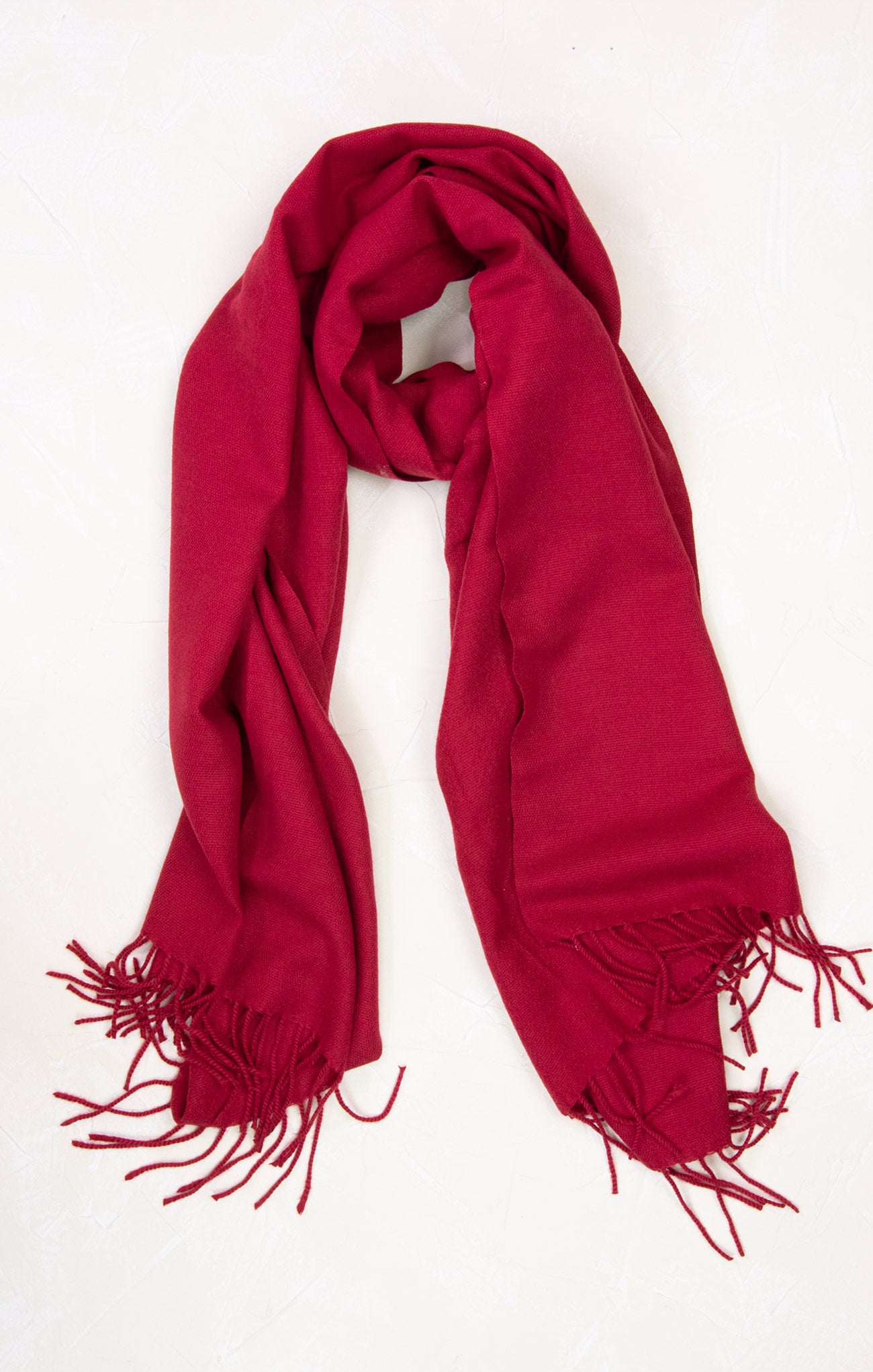 Red scarf with fringes on a white background
