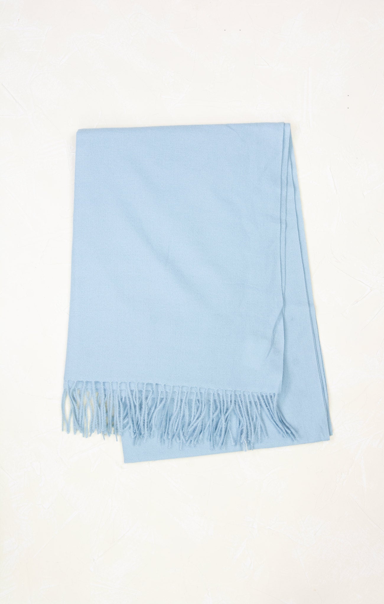 Light blue scarf with fringes on a white background