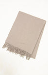 Beige blanket with fringes on a white background
