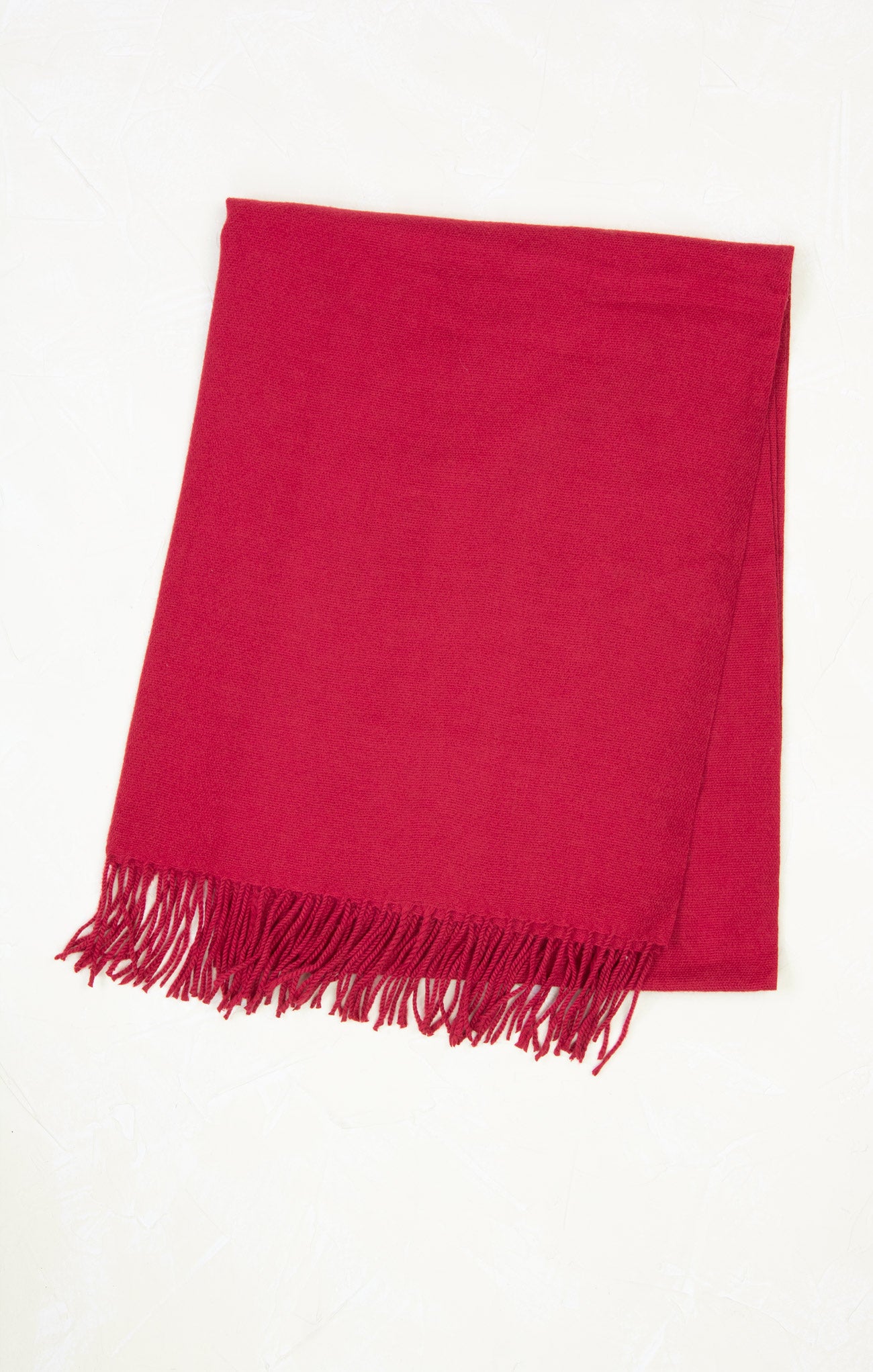 Red scarf with fringes on a white background