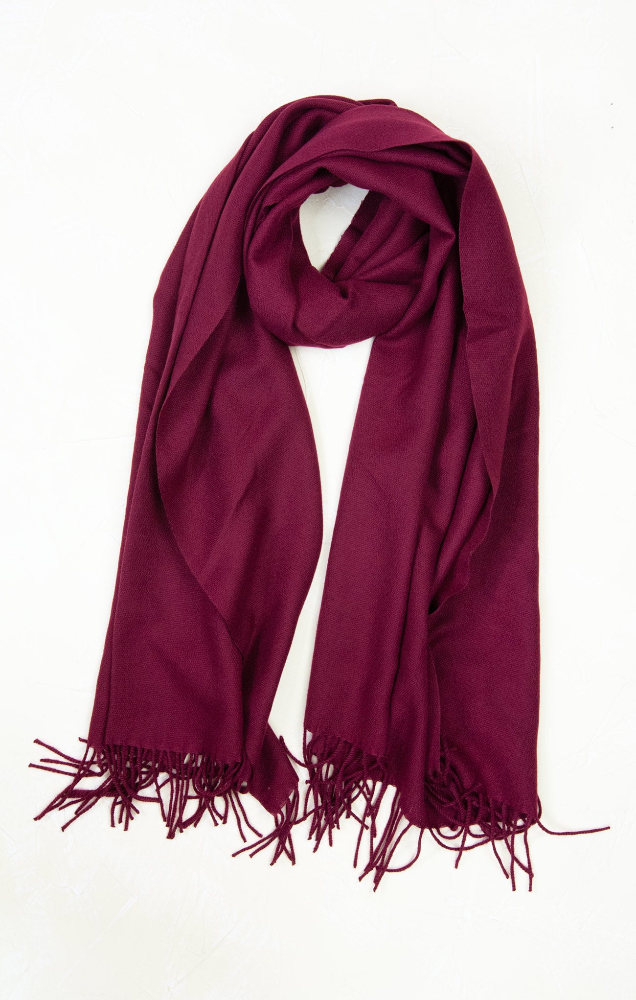 Burgundy scarf with fringes on a white background