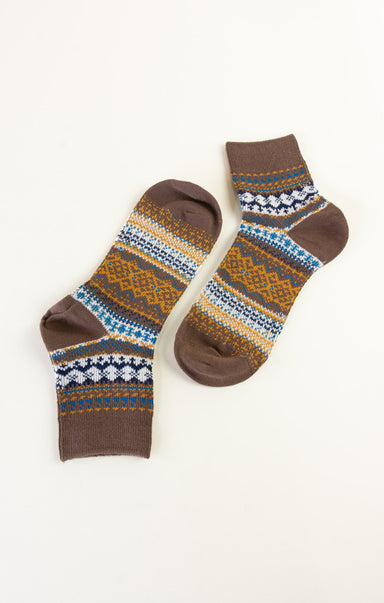 Pair of brown socks with a pattern on a white background