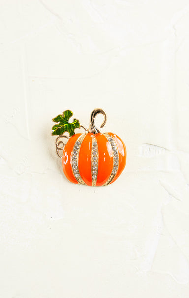 Pumpkin-shaped earring with rhinestone details on a white background
