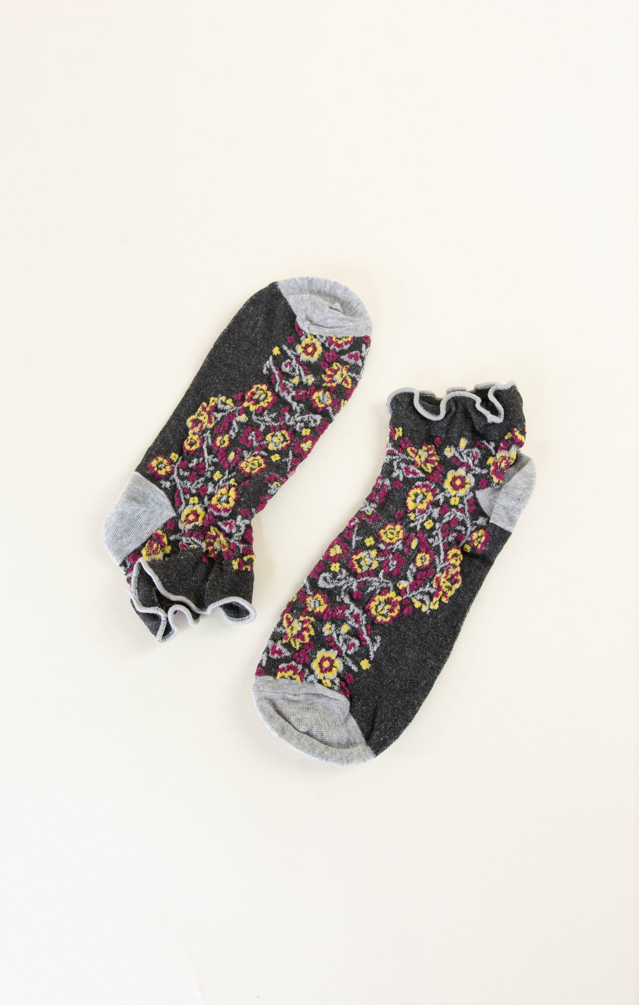 Pair of floral-patterned socks on a white background