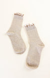 Pair of beige socks with gold accents on a white background
