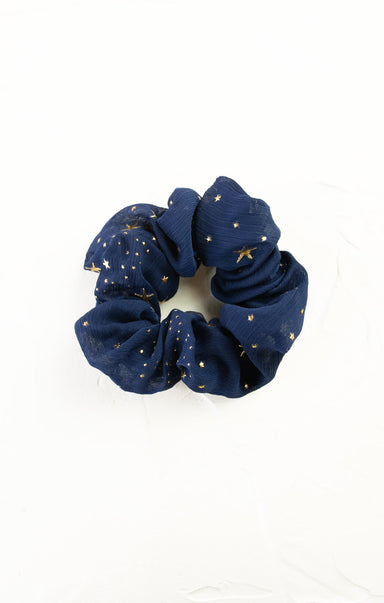 Navy blue scrunchie with gold stars on a white background