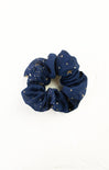 Navy blue scrunchie with gold stars on a white background