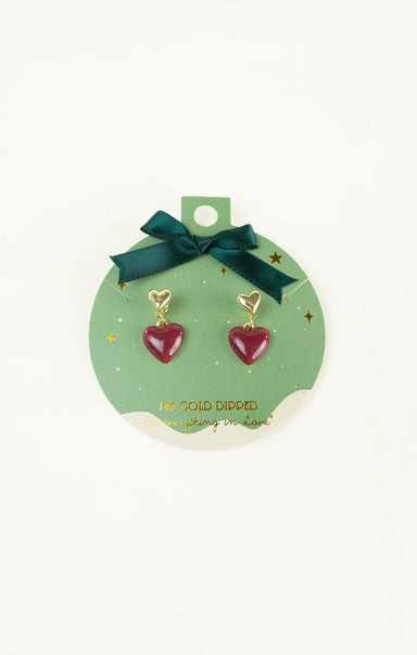 Heart-shaped earrings on a green card with gold accents