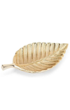 A gold-toned metal leaf-shaped dish with a textured, ribbed surface and a short stem, photographed on a clean white background.