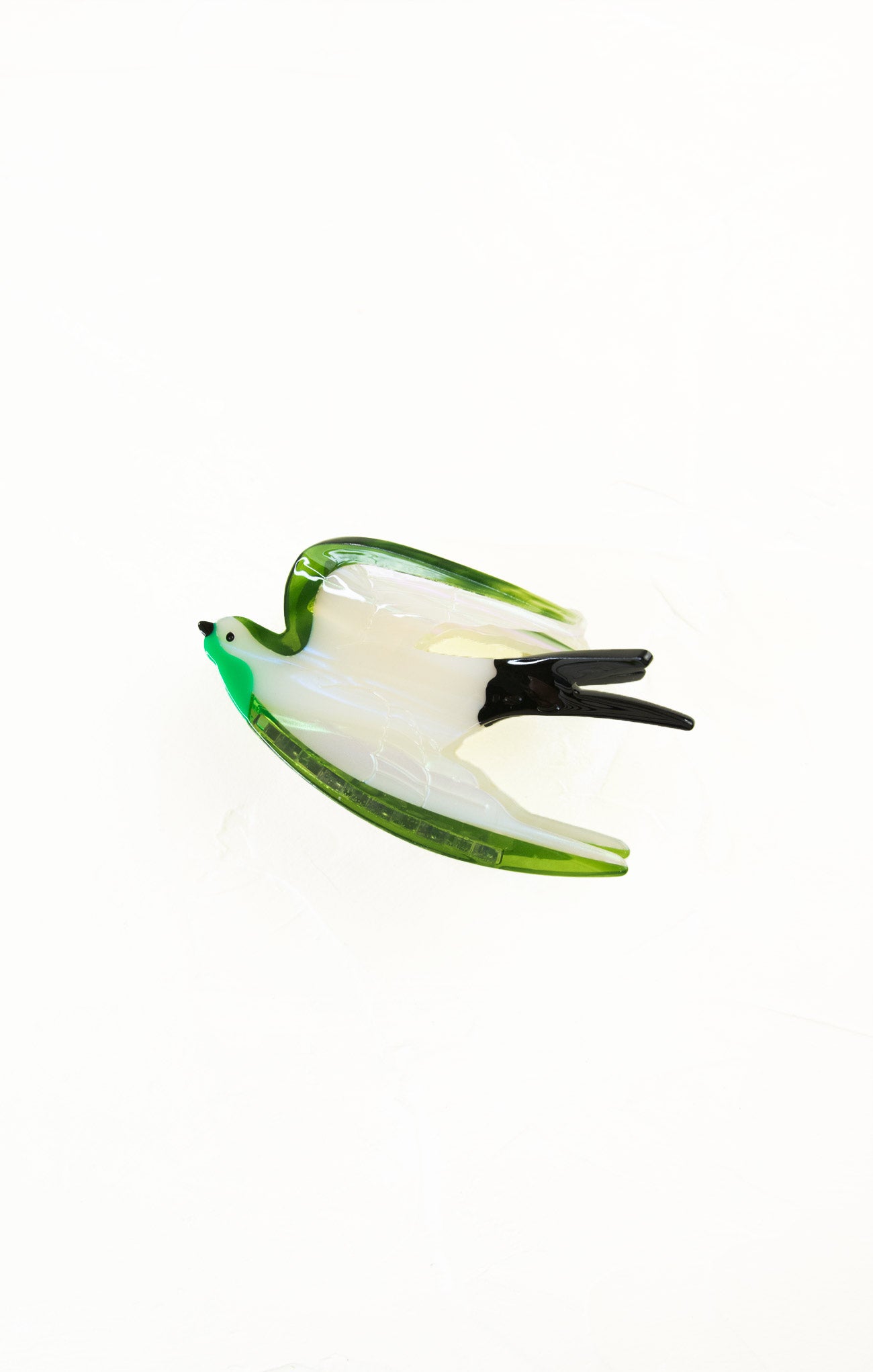 Green and white fishing lure on a white background