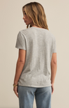 A woman wearing a white short-sleeved crew neck t-shirt with a regular fit, made from a brushed slub jersey fabric.