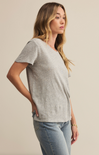 A woman wearing a white short-sleeved crew neck t-shirt with a regular fit, made from a brushed slub jersey fabric.