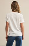 A woman wearing a white short-sleeved crew neck t-shirt with a regular fit, made from a brushed slub jersey fabric.