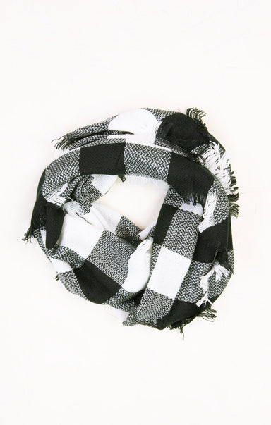 Black and white checkered scarf with fringes on a white background