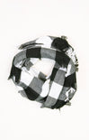Black and white checkered scarf with fringes on a white background