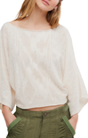 Woman wearing a white blouse and green pants on a white background