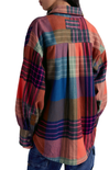 Multicolored plaid shirt worn by a person on a white background
