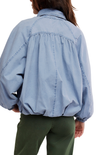Light blue denim jacket worn by a person on a white background