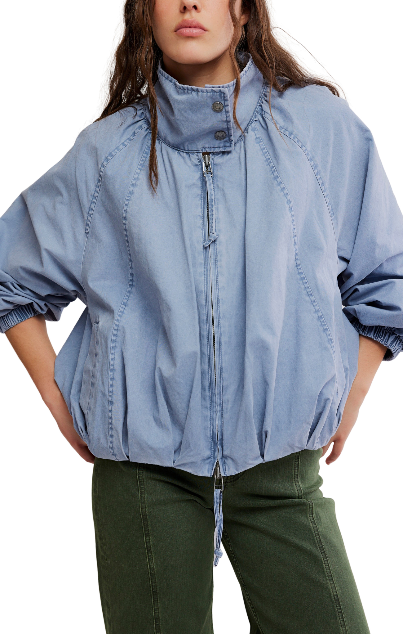 Person wearing a light blue denim jacket with a white background