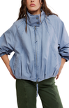 Person wearing a light blue denim jacket with a white background