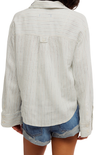Light-colored ribbed sweater worn by a person on a white background