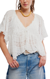Woman wearing a white lace top and blue jeans on a white background