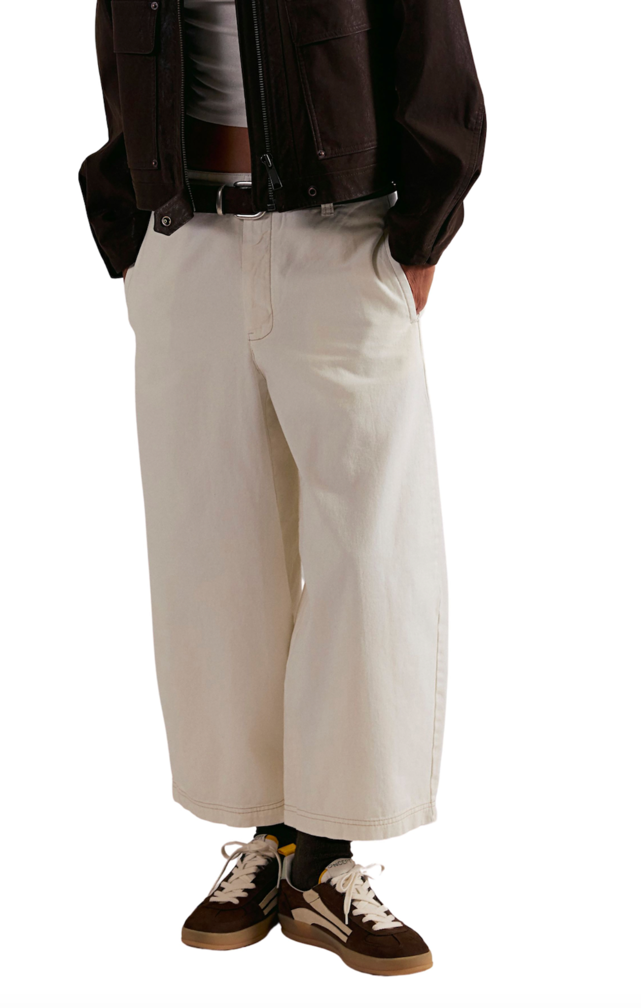 Person wearing beige wide-leg pants on a white background