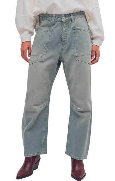 Person wearing light gray cargo pants on a white background