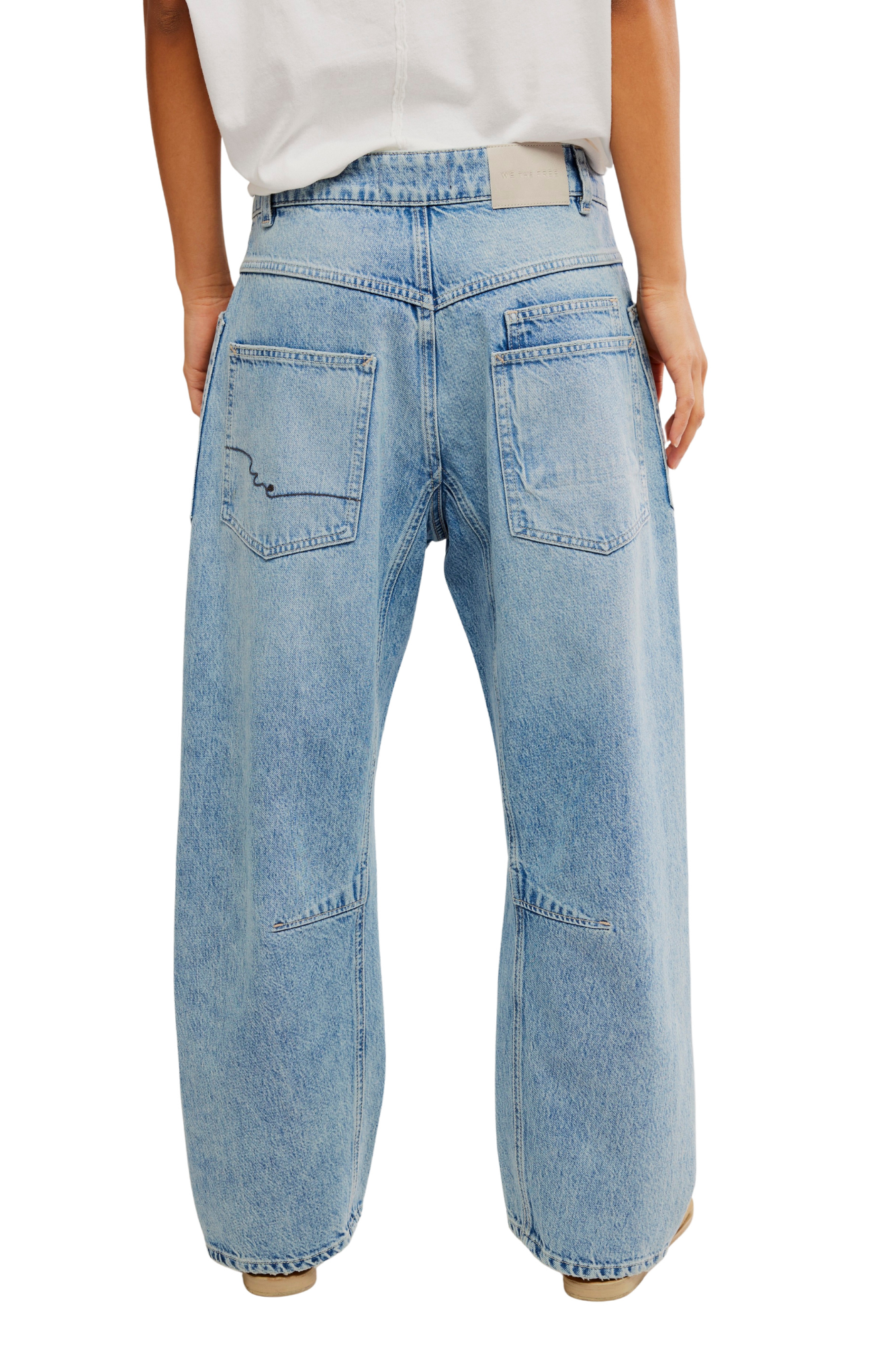Light blue jeans worn by a person on a white background