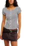 Woman wearing a black and white striped shirt with a brown belt and skirt on a white background