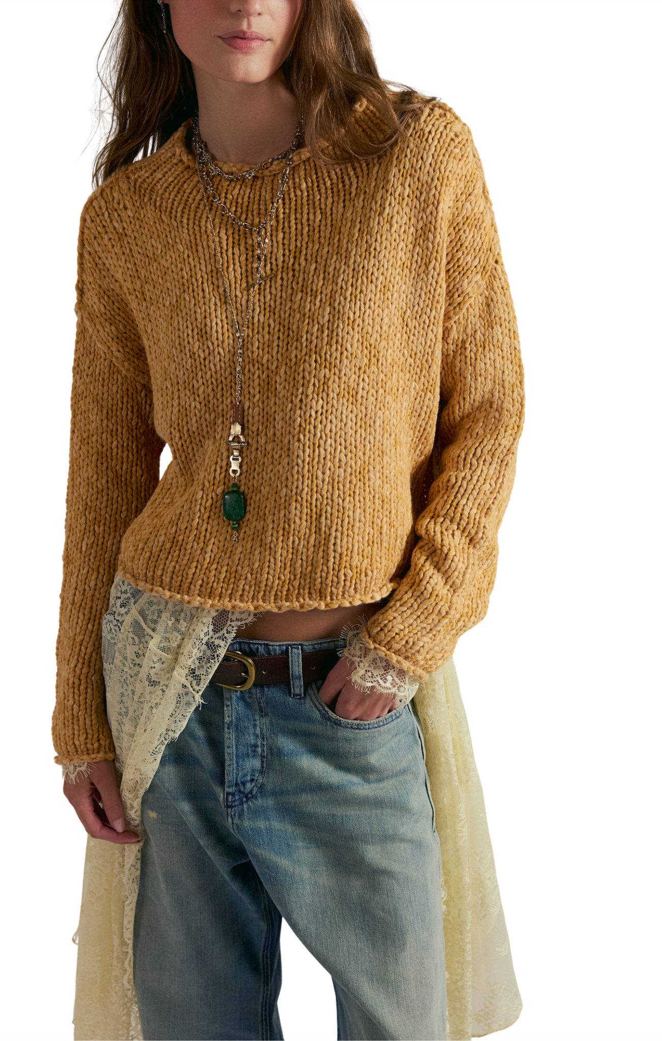 Person wearing a mustard yellow knitted sweater with a white background