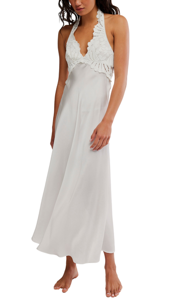 Woman wearing a white halter neck dress on a white background