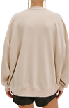 Beige oversized sweatshirt worn by a person on a white background