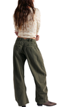 Person wearing olive green wide-leg pants on a white background