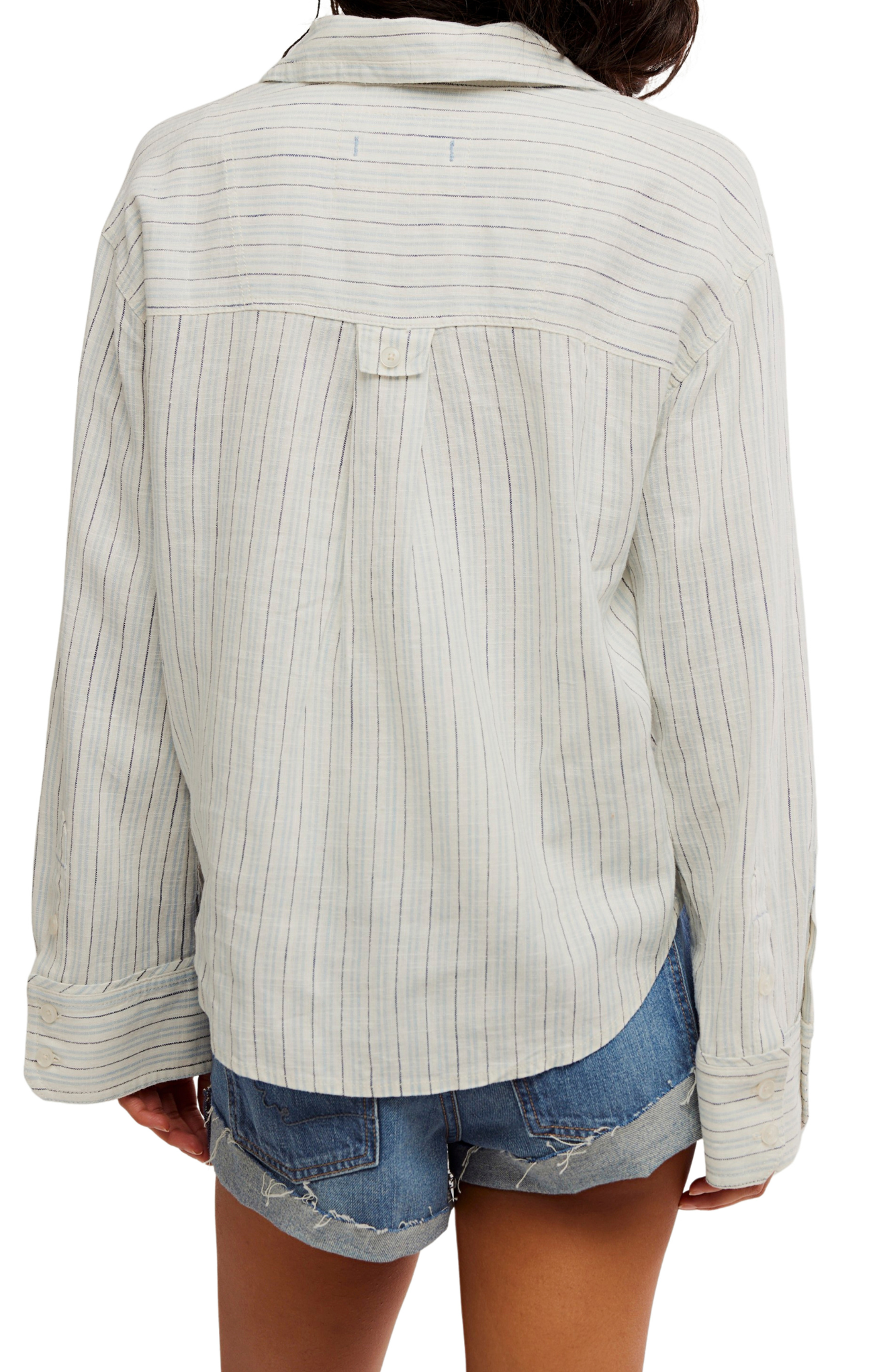 Light-colored ribbed sweater worn by a person on a white background
