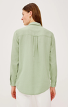 Woman wearing a light green shirt on a white background