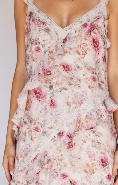 Floral dress with ruffled details on a plain background
