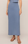 Person wearing a blue skirt on a beige background